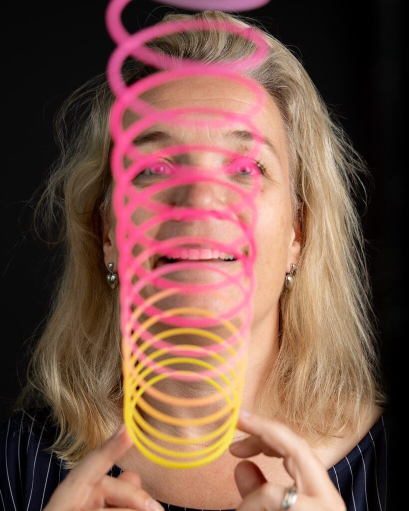 Agnes kijkt lachend door een regenboogveer